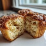Close-up of a cinnamon sugar french toast muffin cut in half, showing its fluffy interior and sugary topping.