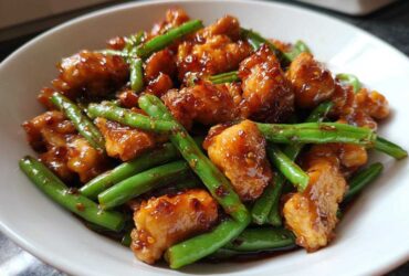 Close-up of saucy, glazed chicken and bright green beans, the perfect 30-minute chicken and green beans dish.