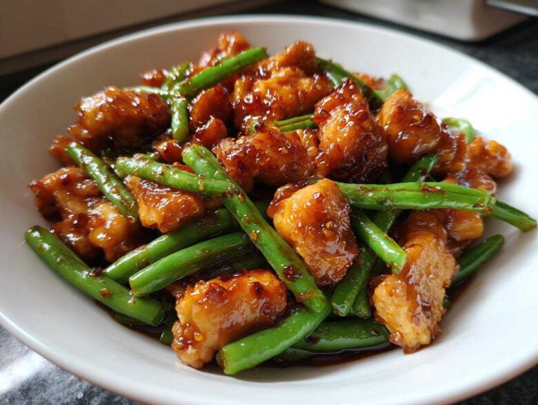 Close-up of saucy, glazed chicken and bright green beans, the perfect 30-minute chicken and green beans dish.