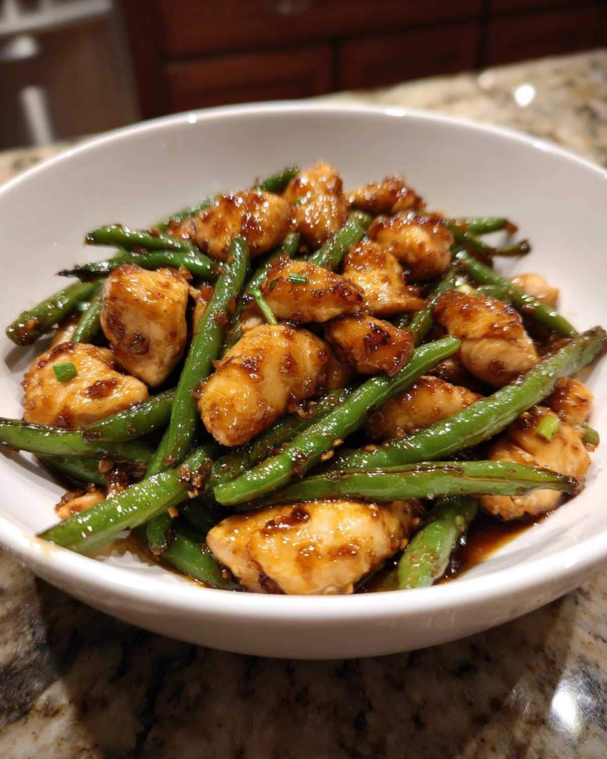 Close-up of saucy chicken and bright green beans, a perfect chicken and green beans dish.