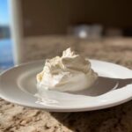A dollop of thick, white, creamy horseradish sauce served on a small white plate.