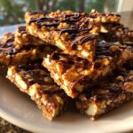 A stack of rich, gooey Pecan Pie Bark squares drizzled generously with dark chocolate.