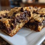 Two squares of Chewy Chocolate Chip Cookie Bars showing a thick, gooey melted chocolate center and golden brown edges.