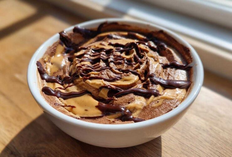 Close-up of Chocolate Peanut Butter Cheesecake Dip swirled with peanut butter and drizzled with chocolate sauce.