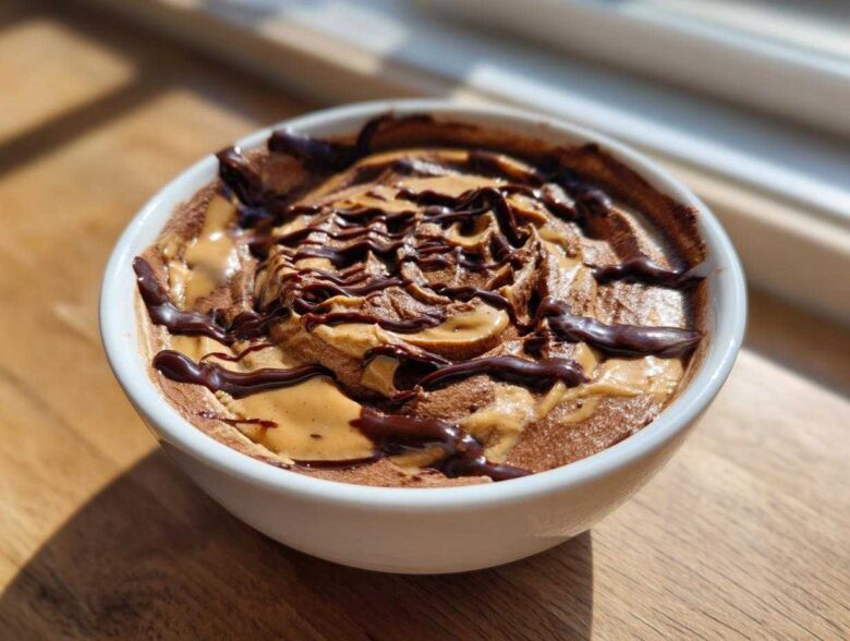 Close-up of Chocolate Peanut Butter Cheesecake Dip swirled with peanut butter and drizzled with chocolate sauce.