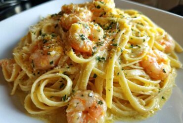 Close-up of rich Creamy Lemon Garlic Shrimp Pasta topped with parsley and zest.