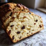 Close-up of thick slices of Easy Irish Soda Bread with Buttermilk and Raisins showing a soft crumb.