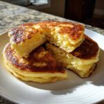 Close-up of fluffy Gluten-Free Buttermilk Pancakes, stacked and cut to show the soft interior texture.