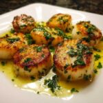 Close-up of seared Garlic Butter Scallops with Lemon, glistening in a bright butter sauce and topped with fresh parsley.