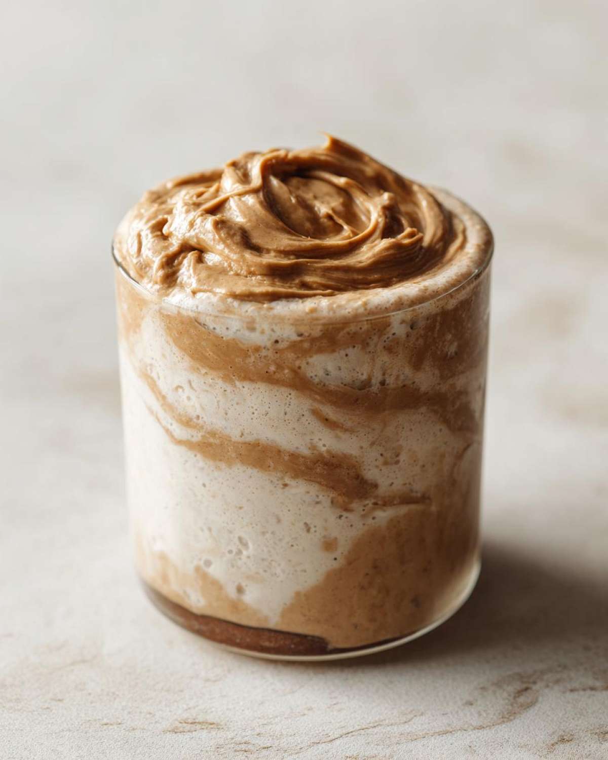 Close-up of High-Protein Peanut Butter Overnight Oats topped with a swirl of creamy peanut butter.