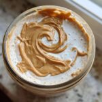 Overhead view of High-Protein Peanut Butter Overnight Oats topped with a beautiful swirl of creamy peanut butter.