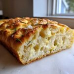 Close-up of the airy crumb of No-Knead Skillet Focaccia with Rosemary, topped with sea salt.