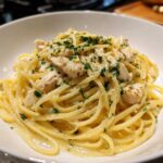 Close-up of Creamy Lemon Chicken Pasta tossed in a light sauce and topped with fresh parsley.