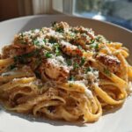 A close-up of creamy Garlic Butter Chicken Pasta with Parmesan, topped with fresh parsley.