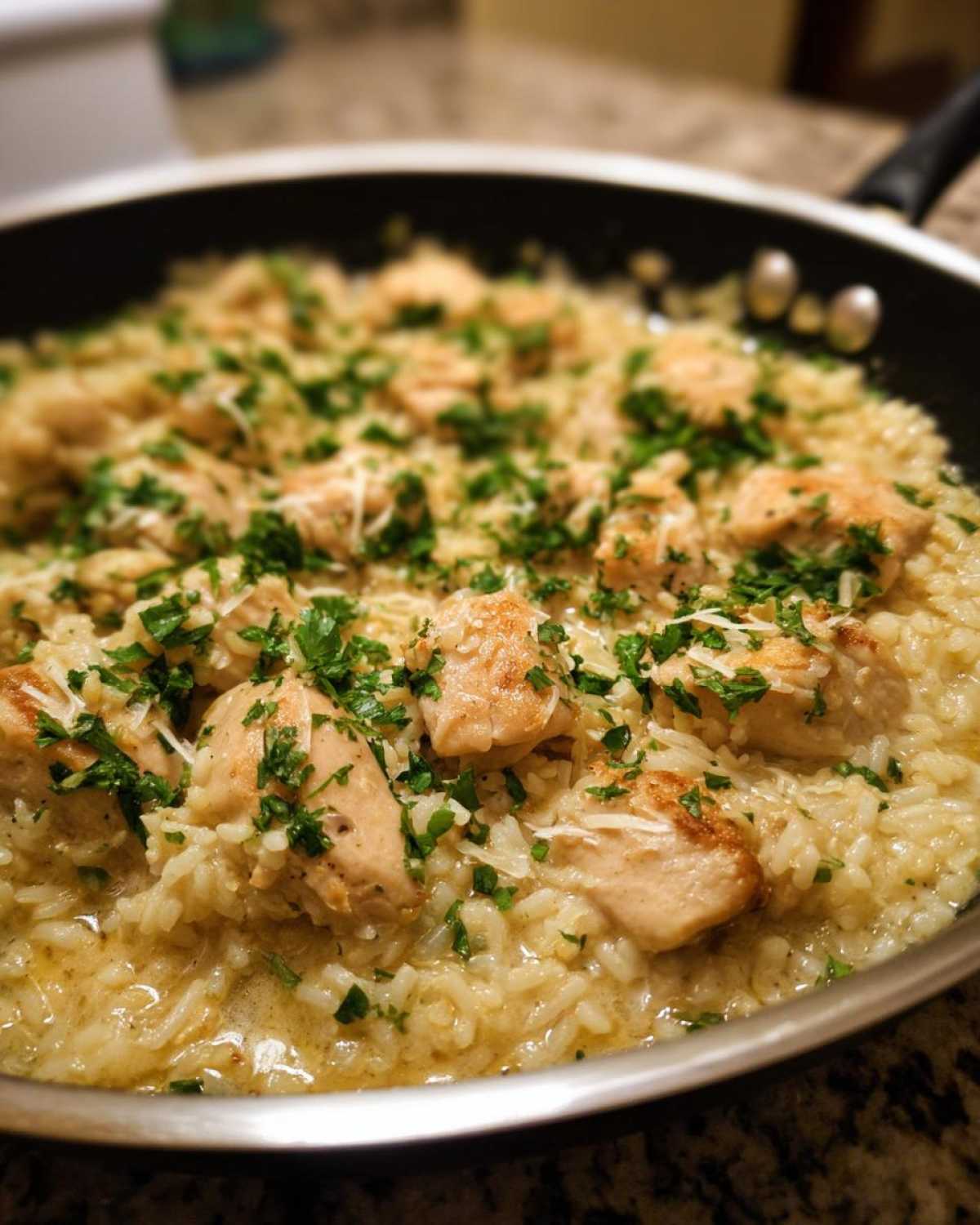 Close-up of creamy Garlic Butter Rice with Chicken Skillet topped with parsley.