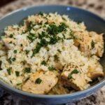 Close-up of Garlic Butter Rice with Chicken Skillet, topped with fresh parsley and grated cheese.