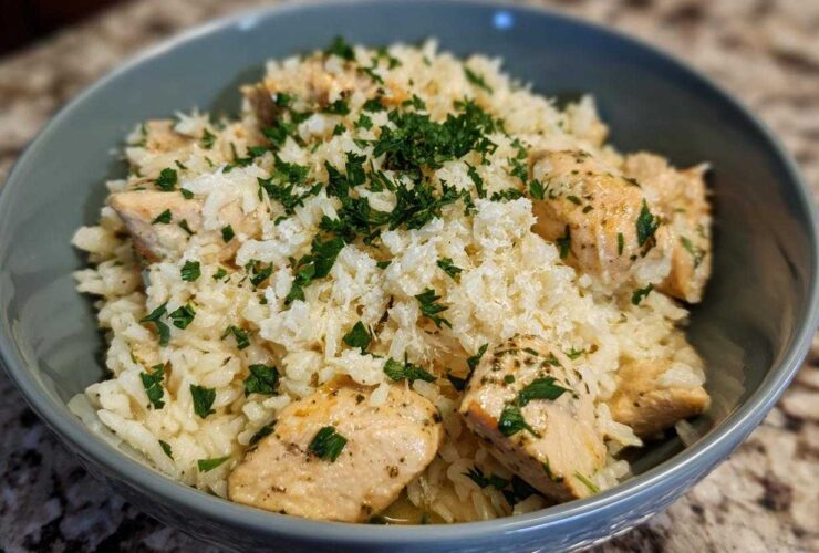 Close-up of Garlic Butter Rice with Chicken Skillet, topped with fresh parsley and grated cheese.