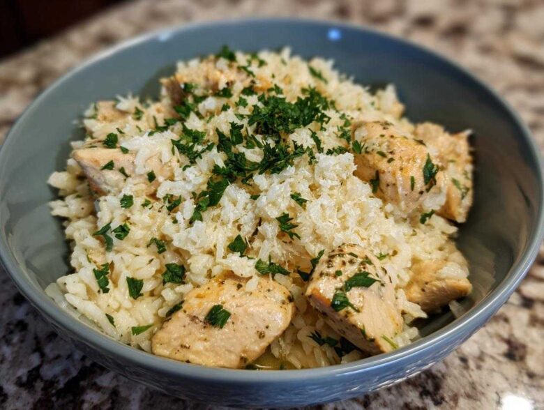 Close-up of Garlic Butter Rice with Chicken Skillet, topped with fresh parsley and grated cheese.