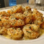 A close-up of plump shrimp coated in a rich Garlic Butter Shrimp with Creamy Parmesan Sauce, garnished with parsley.