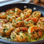 Close-up of succulent shrimp cooking in a skillet, coated in rich garlic butter and herbs for Garlic Butter Shrimp Skillet.