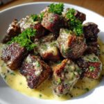 Close-up of seared Garlic Butter Steak Bites generously coated in creamy garlic sauce and garnished with parsley.