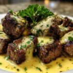 Close-up of seared Garlic Butter Steak Bites smothered in a rich, creamy garlic sauce and garnished with parsley.