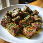 Close-up of perfectly seared Garlic Butter Steak Bites with Juicy Center coated in garlic and herbs.