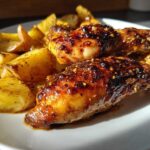 Close-up of glazed chicken drumsticks and roasted potatoes from Honey Mustard Chicken Bake with Potatoes.