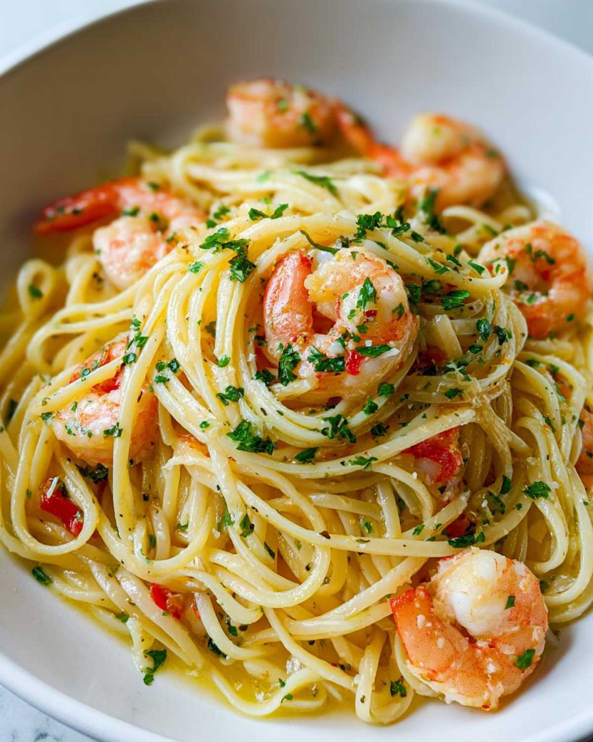 Close-up of luscious Lemon Butter Shrimp Pasta Ready in 20 Minutes, tossed in a light sauce and garnished with parsley.