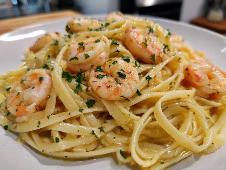 Close-up of a plate featuring Lemon Butter Shrimp Pasta Ready in 20 Minutes, topped with plump shrimp and fresh parsley.