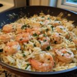 Close-up of creamy Lemon Garlic Shrimp Orzo one pan dinner garnished with fresh parsley in a skillet.