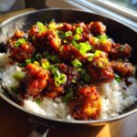 Close-up of Sticky Sweet Chili Chicken Skillet served over white rice and garnished with fresh green onions.
