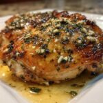 Close-up of perfectly cooked Baked Chicken Thighs with Garlic Butter Sauce, glistening with herbs.