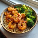 Close-up of a Honey Garlic Shrimp Bowls featuring glazed shrimp, steamed broccoli, and brown rice.
